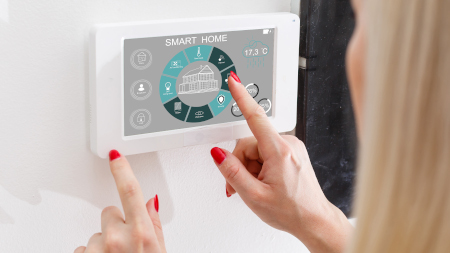 Woman use application for smart home control on tablet