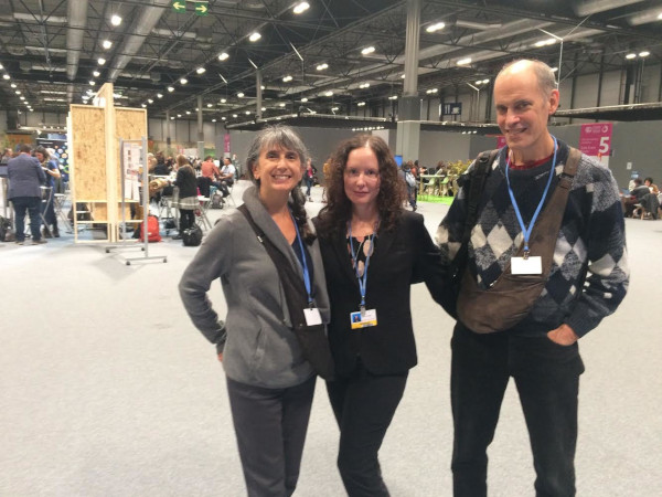 Heidi Brault, Regina Valdez and Charles Gregoire standing in the lobby of the COP25 venue